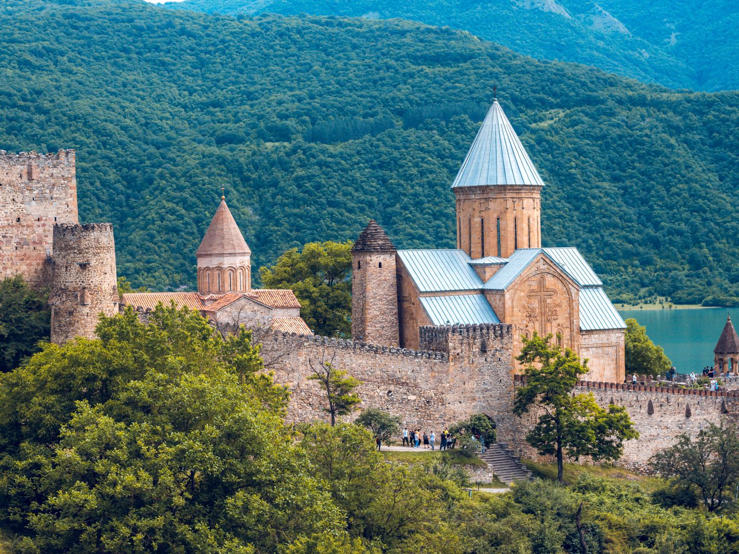 Ananuri Fortress nestled in lush Georgian forests by the Aragvi River with medieval architecture.