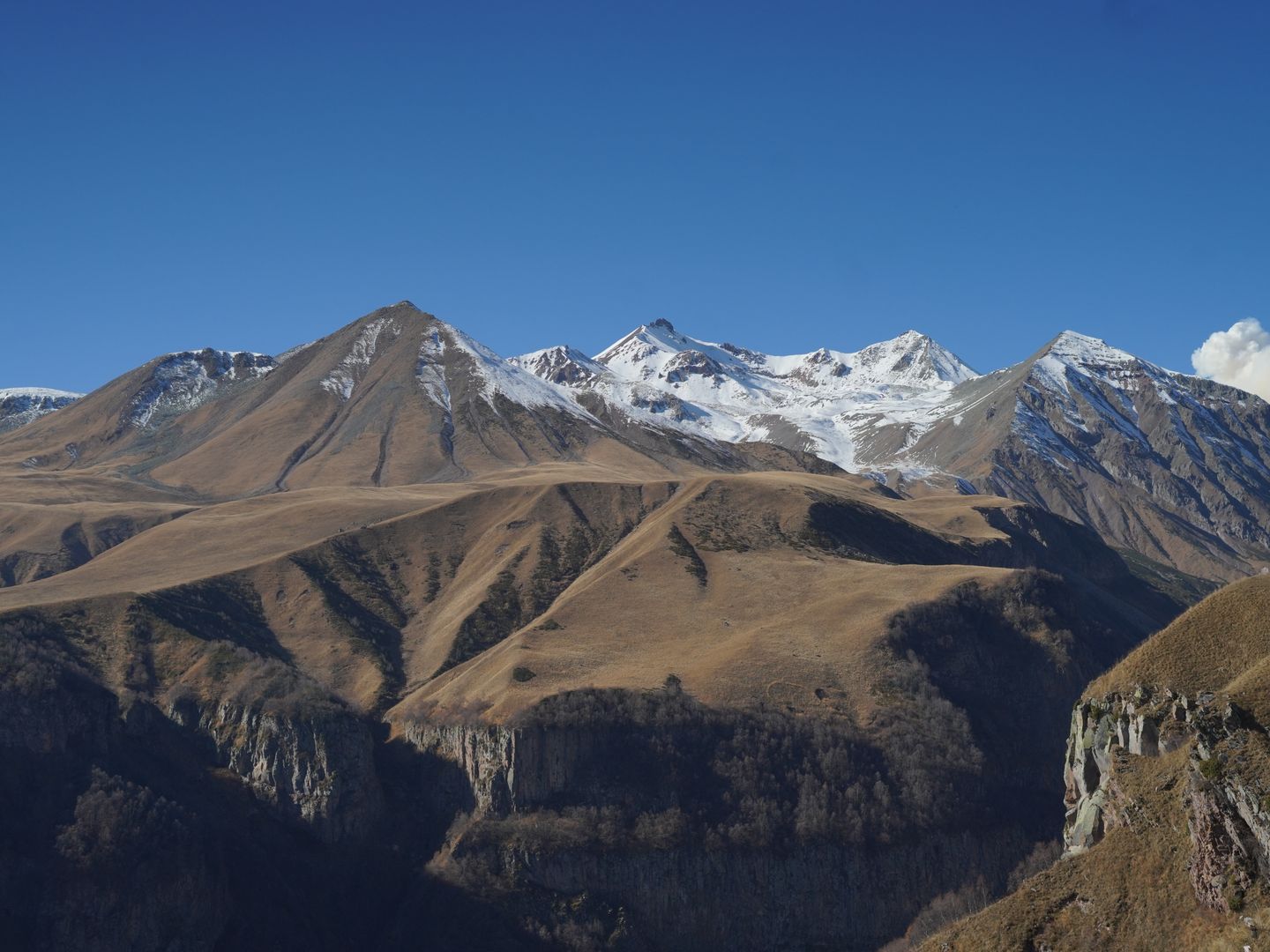 Breathtaking view of the Caucasus mountains with clear blue sky in Georgia.