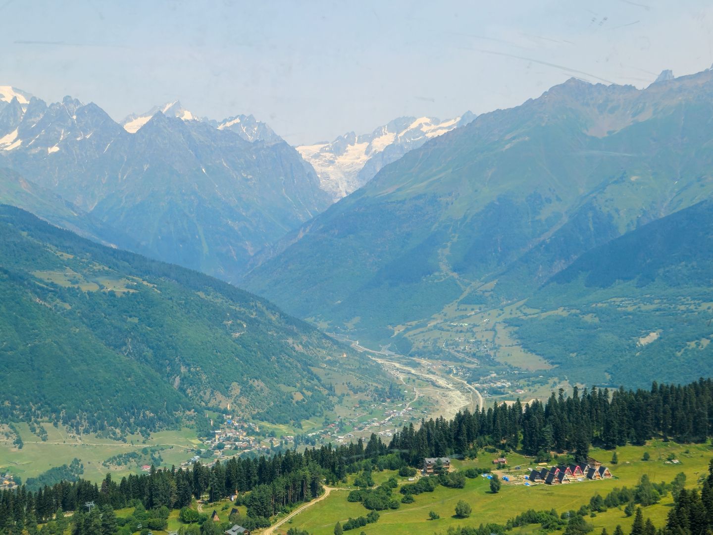 Breathtaking view of the Caucasus Mountains in Mestia, Georgia under a clear summer sky.